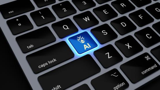Laptop keyboard with the 'AI' appearing on the 'A' key and lit up blue with a robot logo.